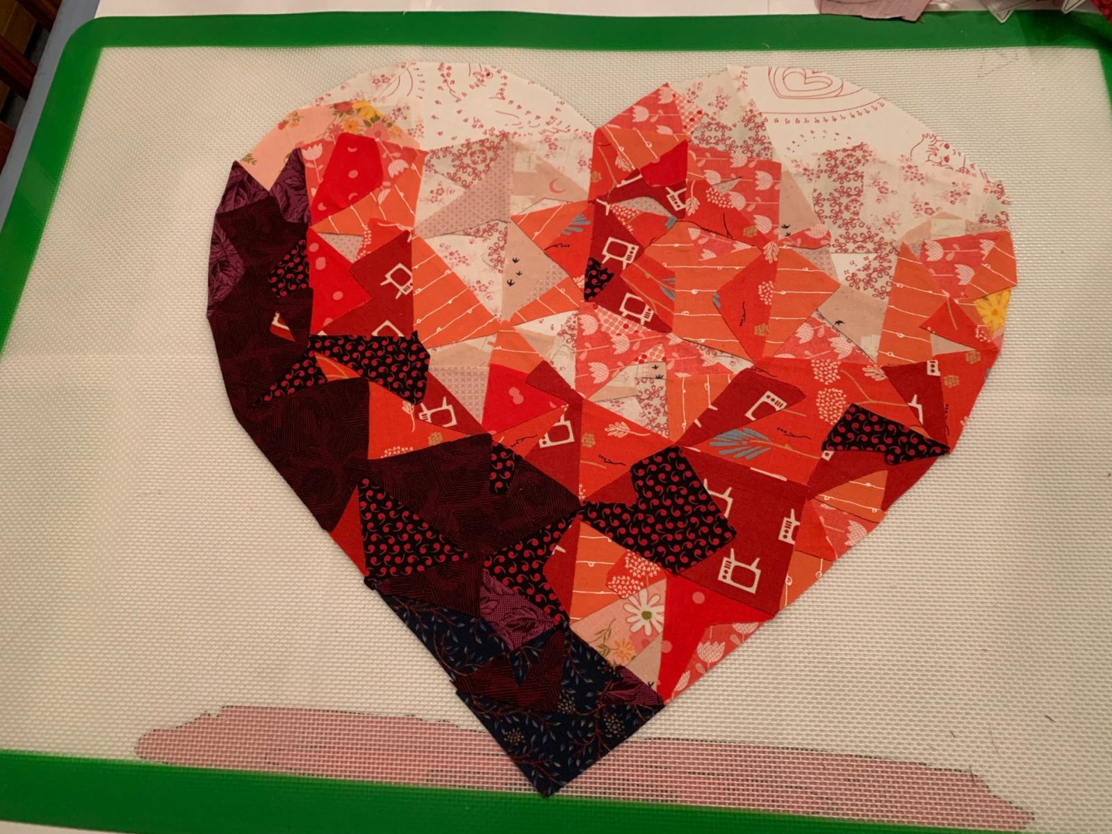 AI-inspired geometric heart quilt block in bold colors by The AI Quilter.