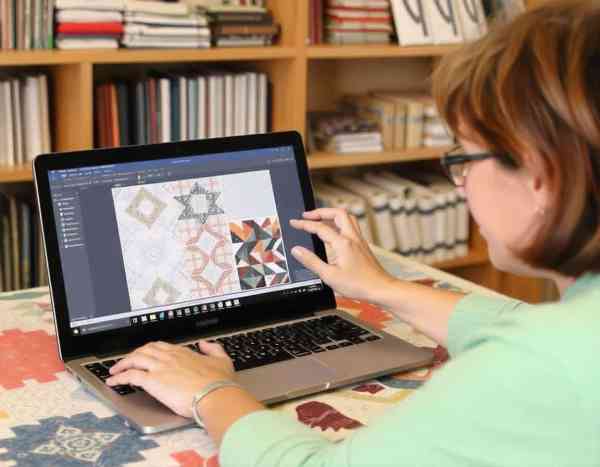ai generated image of woman creating quilt pattern on computer