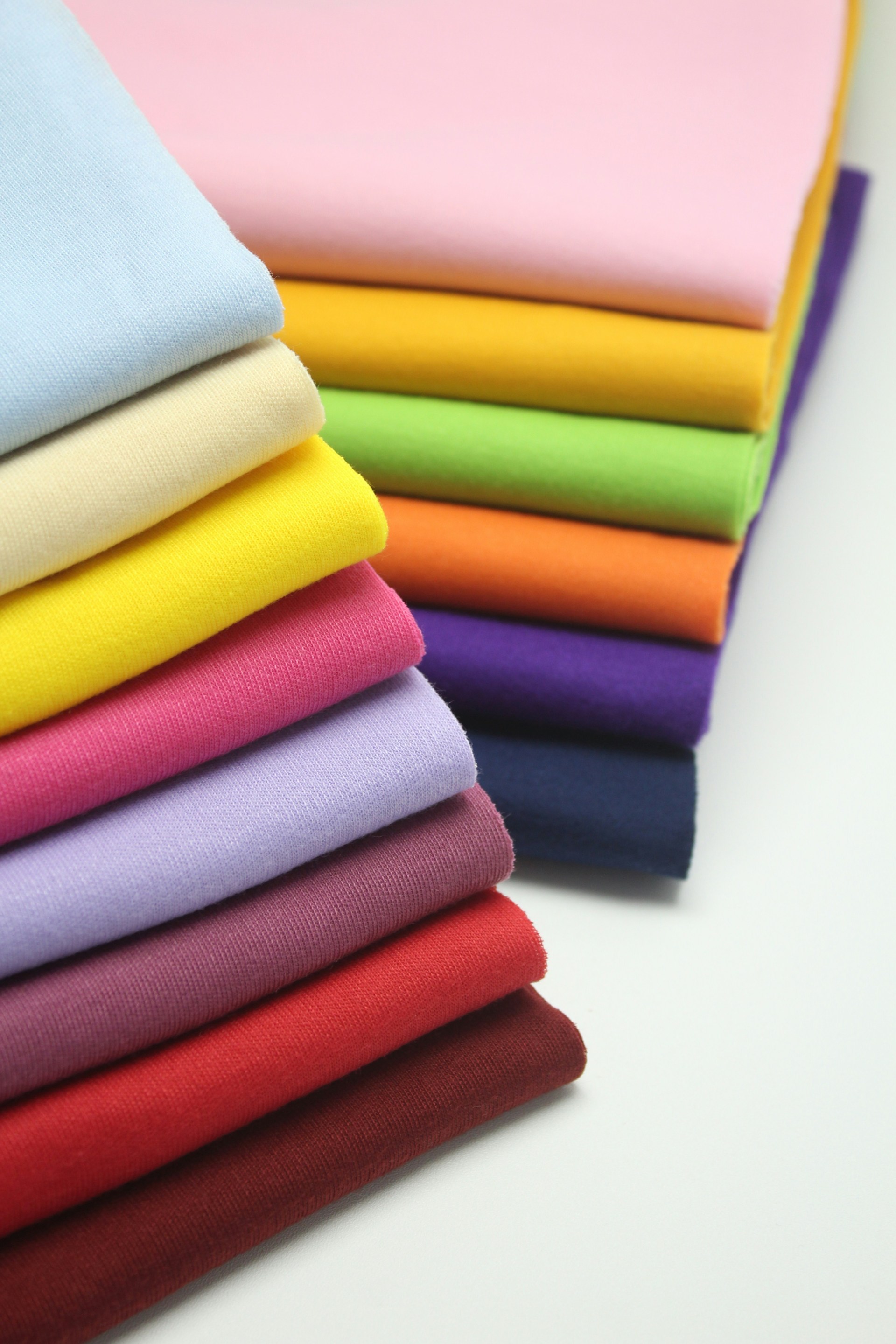 Stacks of fabric yardage with rainbow colors